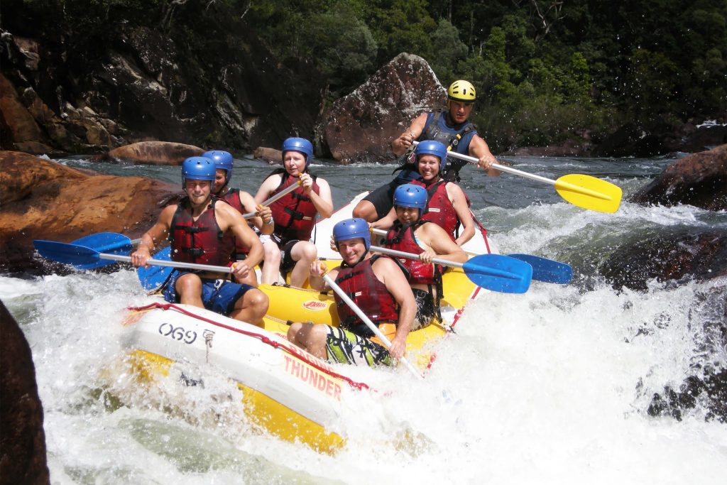 group of people white water rafting