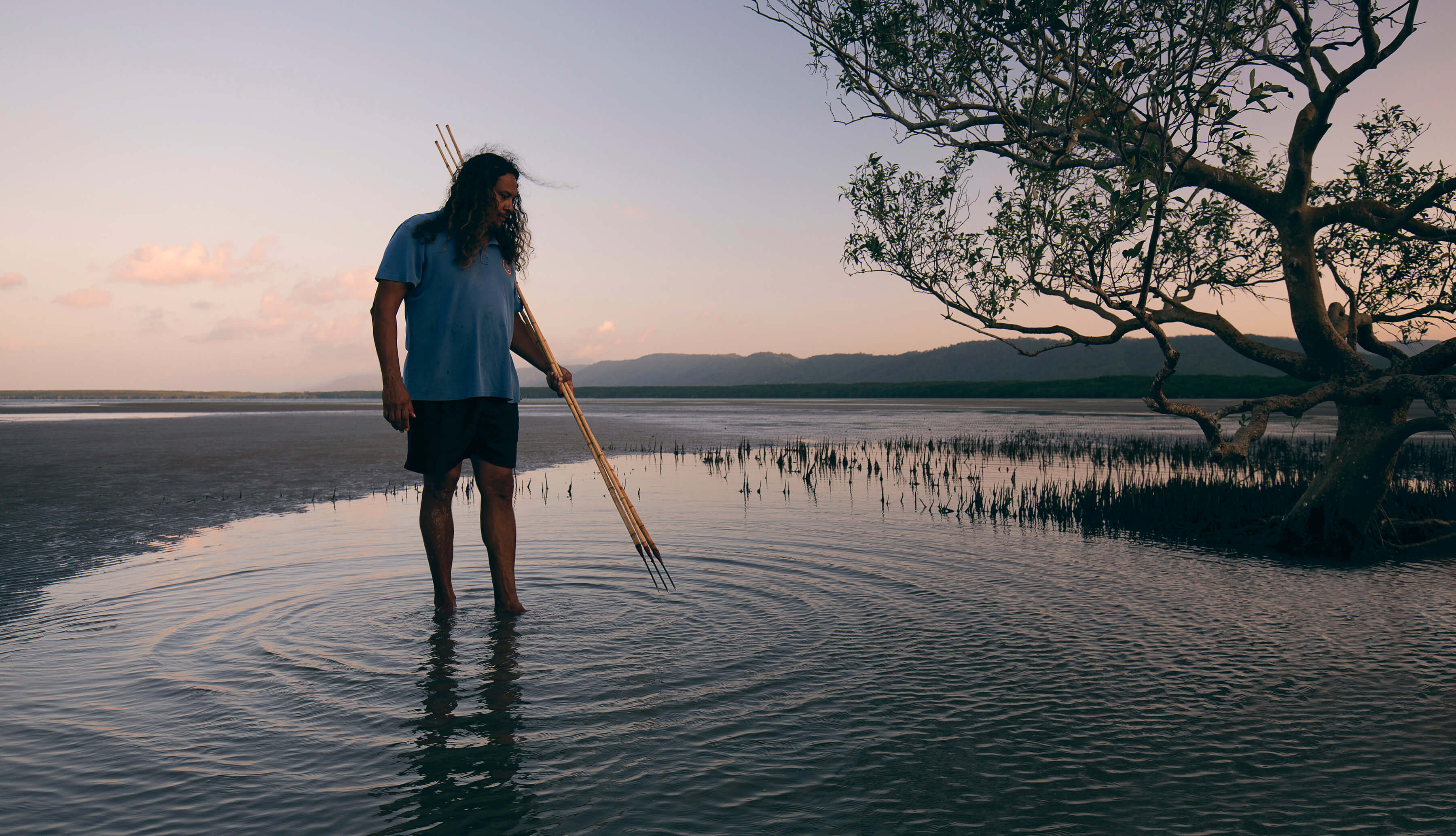 Standing on the beach with spear